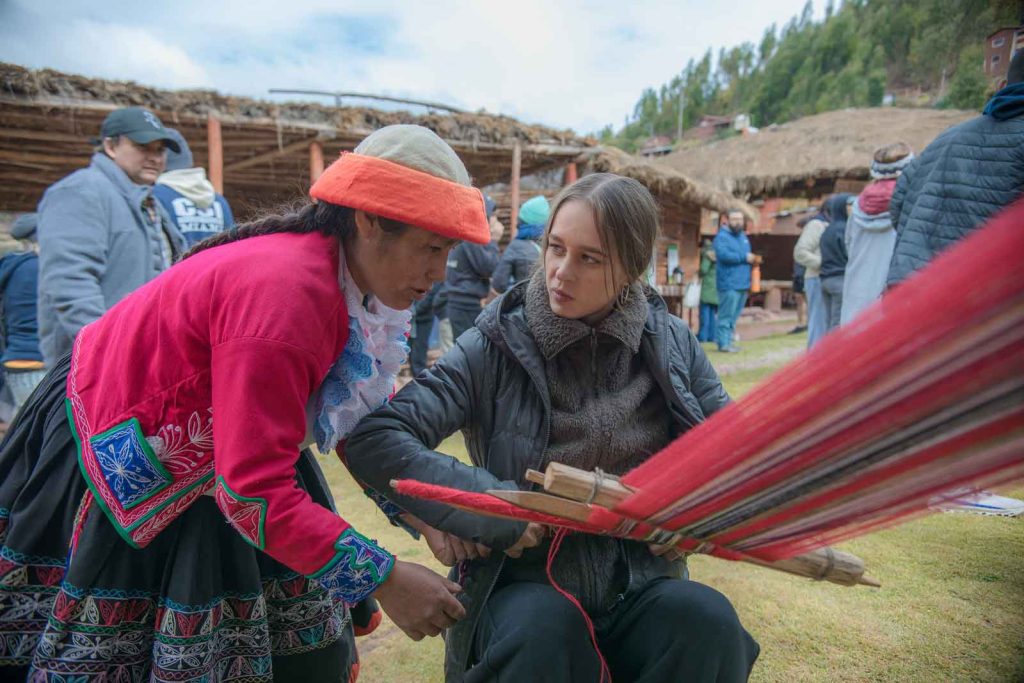 Woman and student weaving in Peru